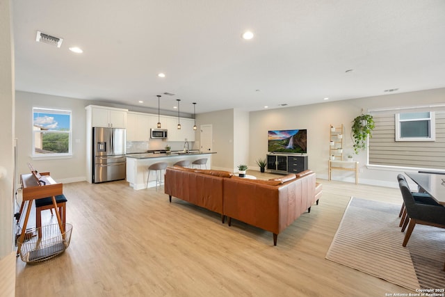 1618 W Lawndale Unit, San Antonio, TX 78209 - living area featuring recessed lighting, light wood finished floors, and baseboards