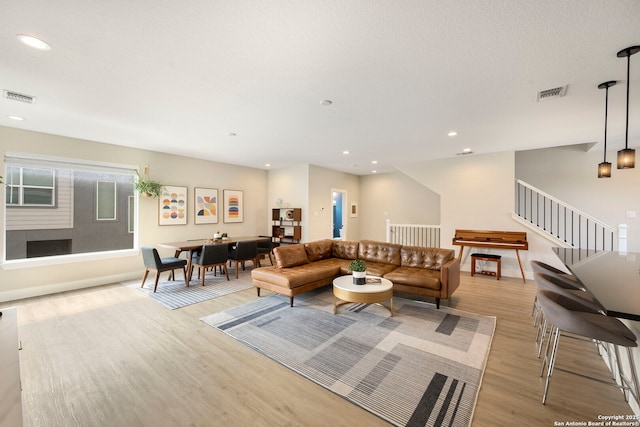1618 W Lawndale Unit, San Antonio, TX 78209 - living area with light wood-style flooring, recessed lighting, stairs, and baseboards
