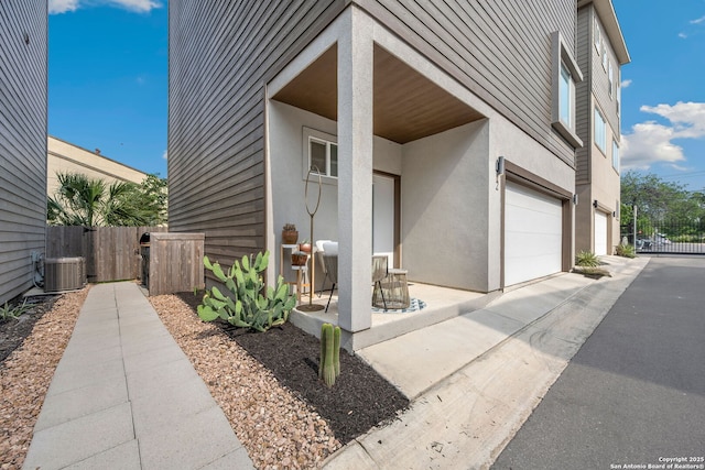 1618 W Lawndale # 2, San Antonio, TX 78209 - entrance to property featuring stucco siding, an attached garage, central AC, driveway, and a gate