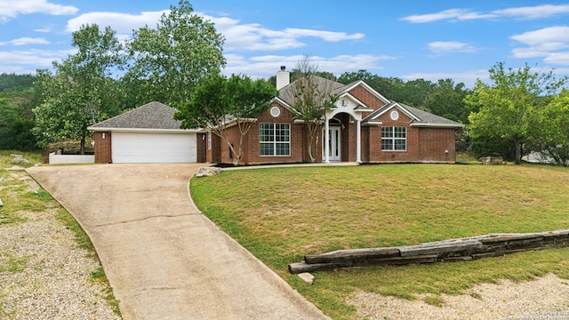 113 Fannin Dr, Kerrville, TX 78028 - view of front of home with driveway, a front yard, a chimney, brick siding, and a garage