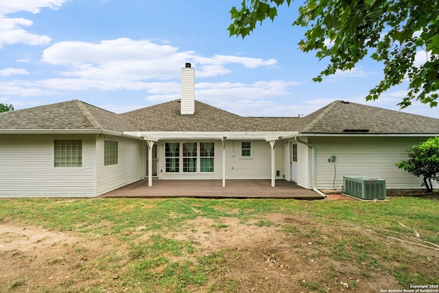 113 Fannin Dr, Kerrville, TX 78028 - back of house featuring central AC, a chimney, a yard, and roof with shingles