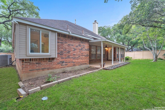 3419 Pinto Pony Ln, San Antonio, TX 78247 - back of house with cooling unit, a patio, a chimney, a ceiling fan, and brick siding