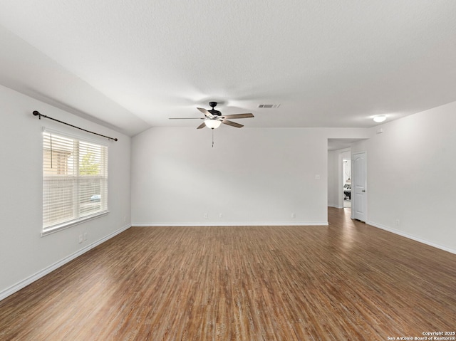 412 Town Frk, Cibolo, TX 78108 - spare room with a ceiling fan, wood finished floors, baseboards, vaulted ceiling, and a textured ceiling