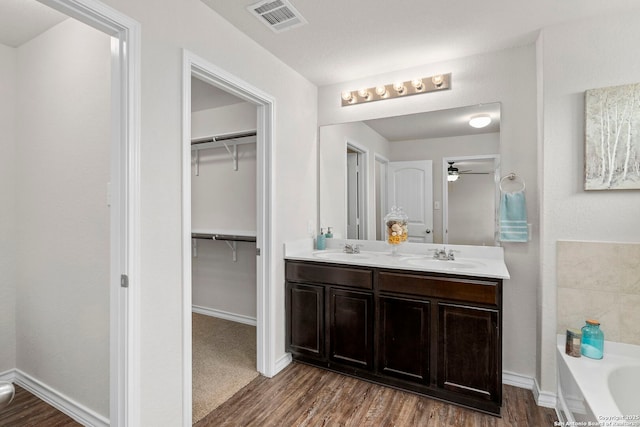412 Town Frk, Cibolo, TX 78108 - full bath with wood finished floors, double vanity, and a garden tub