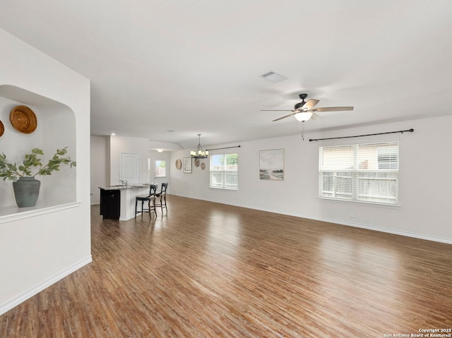412 Town Frk, Cibolo, TX 78108 - unfurnished living room featuring wood finished floors, a ceiling fan, a chandelier, and baseboards
