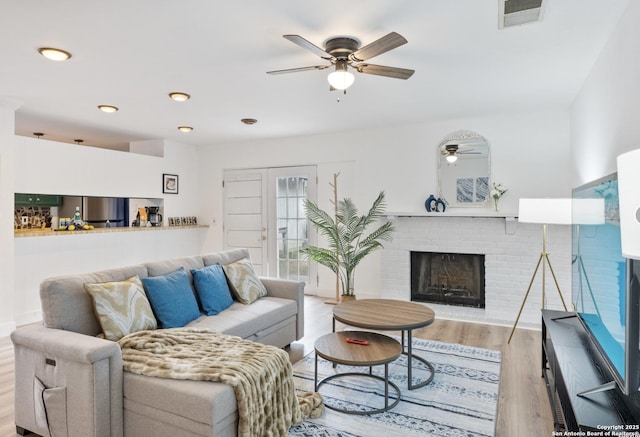 16414 Spruce Cove St, San Antonio, TX 78247 - living room featuring a ceiling fan, a fireplace, and wood finished floors