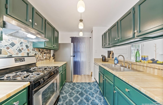 16414 Spruce Cove St, San Antonio, TX 78247 - kitchen with stainless steel appliances, a sink, under cabinet range hood, light countertops, and green cabinetry