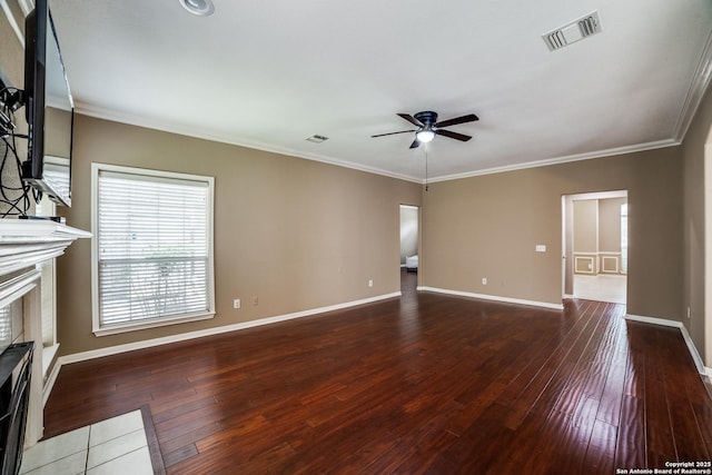 5018 Ashton Audrey, San Antonio, TX 78249 - unfurnished living room featuring ceiling fan, a fireplace, hardwood / wood-style flooring, baseboards, and crown molding