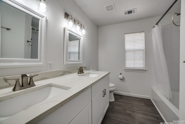 5018 Ashton Audrey, San Antonio, TX 78249 - full bath featuring double vanity, toilet, wood finished floors, baseboards, and shower / tub combo with curtain