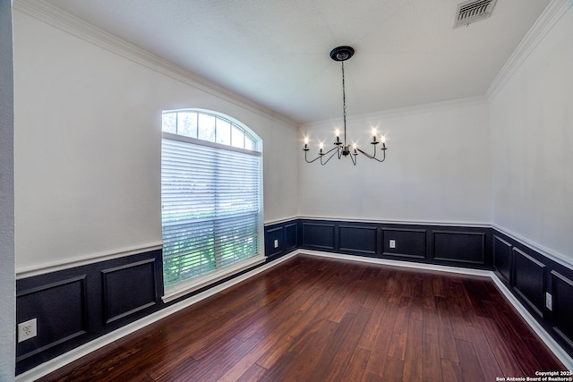 5018 Ashton Audrey, San Antonio, TX 78249 - unfurnished dining area with a chandelier, ornamental molding, dark wood finished floors, wainscoting, and a decorative wall