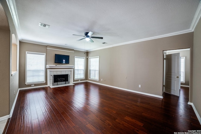 5018 Ashton Audrey, San Antonio, TX 78249 - unfurnished living room with ceiling fan, dark wood finished floors, baseboards, crown molding, and a tile fireplace