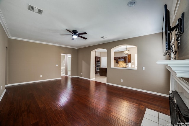 5018 Ashton Audrey, San Antonio, TX 78249 - unfurnished living room featuring ceiling fan, wood-type flooring, a fireplace with flush hearth, arched walkways, and baseboards