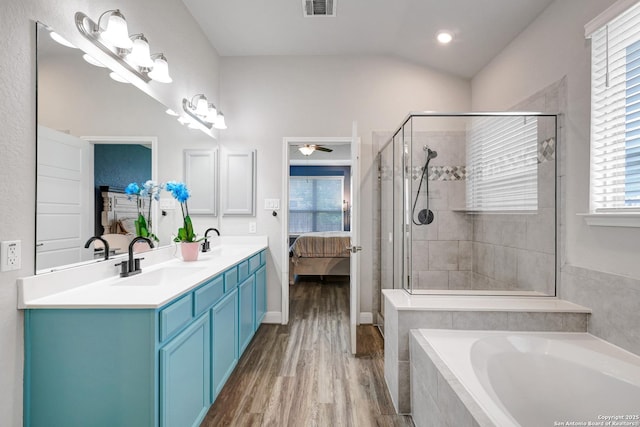 2423 Olive Way, San Antonio, TX 78259 - bathroom with ensuite bath, a garden tub, wood finished floors, double vanity, and vaulted ceiling