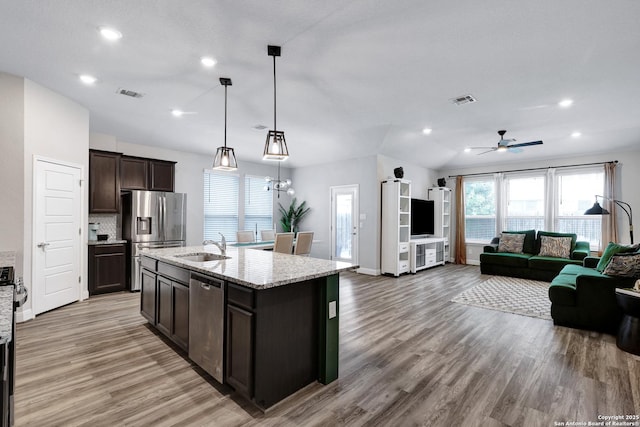 2423 Olive Way, San Antonio, TX 78259 - kitchen featuring appliances with stainless steel finishes, open floor plan, light wood-style floors, dark brown cabinets, and recessed lighting