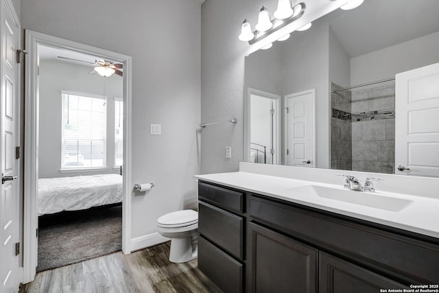 2423 Olive Way, San Antonio, TX 78259 - ensuite bathroom featuring toilet, vanity, wood finished floors, ceiling fan, and a tile shower