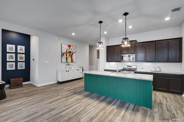 2423 Olive Way, San Antonio, TX 78259 - kitchen featuring stainless steel appliances, light wood-style floors, backsplash, dark brown cabinets, and recessed lighting