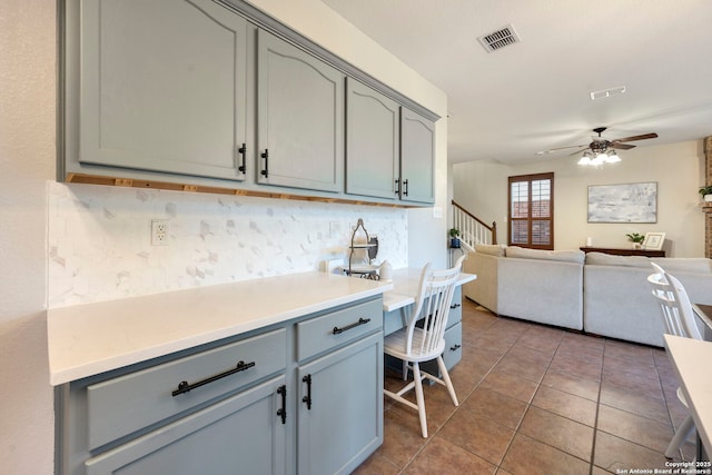 6110 Briscoe Leaf, San Antonio, TX 78253 - kitchen with gray cabinetry, ceiling fan, tasteful backsplash, tile patterned floors, and open floor plan