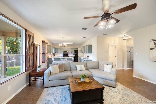 6110 Briscoe Leaf, San Antonio, TX 78253 - living room featuring dark tile patterned flooring, baseboards, a ceiling fan, and a chandelier