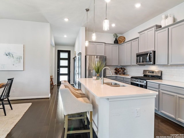 11547 Lightning Way, San Antonio, TX 78245 - kitchen with stainless steel appliances, a sink, gray cabinetry, tasteful backsplash, and recessed lighting