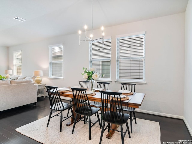 11547 Lightning Way, San Antonio, TX 78245 - dining area featuring a chandelier, baseboards, and wood finished floors