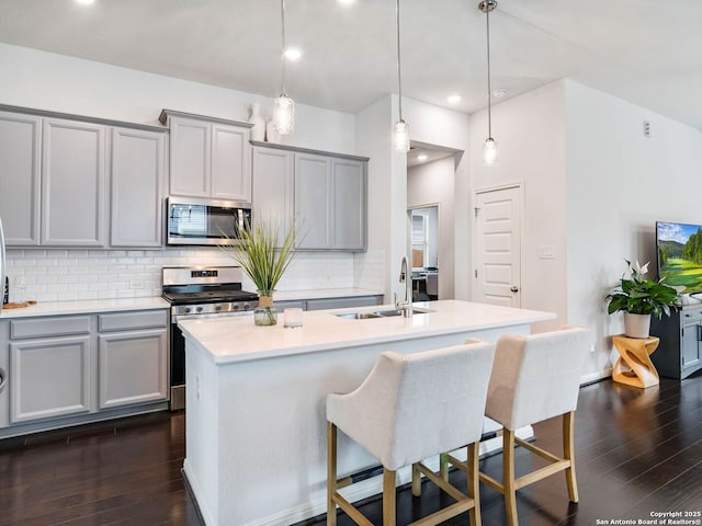 11547 Lightning Way, San Antonio, TX 78245 - kitchen featuring appliances with stainless steel finishes, a sink, gray cabinetry, decorative backsplash, and recessed lighting