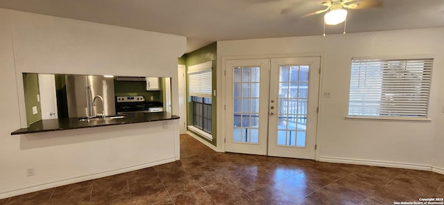 8611 Datapoint Unit 59, San Antonio, TX 78229 - doorway to outside with ceiling fan, a sink, french doors, dark tile patterned flooring, and baseboards