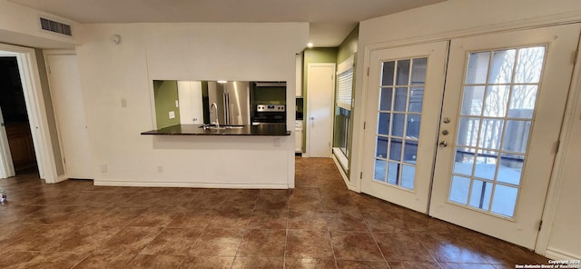 8611 Datapoint Unit 59, San Antonio, TX 78229 - unfurnished living room featuring french doors, a sink, and dark tile patterned floors