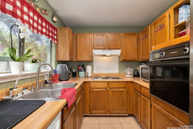 6283 Valley Bay, San Antonio, TX 78250 - kitchen featuring black oven, under cabinet range hood, light tile patterned floors, a sink, and white electric cooktop