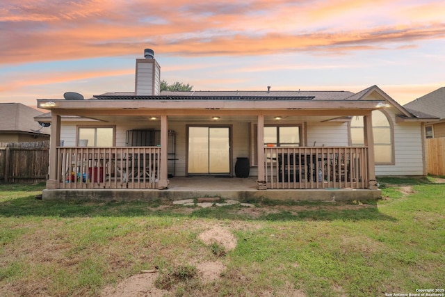 1842 Wayward, Pleasanton, TX 78064 - back of house at dusk with a chimney