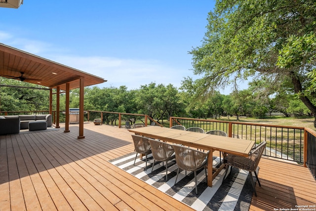 102 Kendall View Dr, Boerne, TX 78006 - wooden terrace with outdoor dining area, an outdoor living space, a ceiling fan, and view of scattered trees