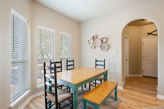 102 Kendall View Dr, Boerne, TX 78006 - dining space featuring arched walkways, light wood-style flooring, and baseboards