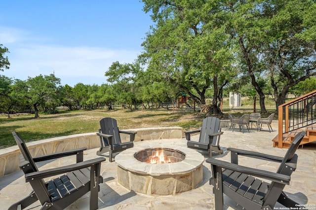 102 Kendall View Dr, Boerne, TX 78006 - view of patio / terrace featuring an outdoor fire pit, a playground, and view of wooded area
