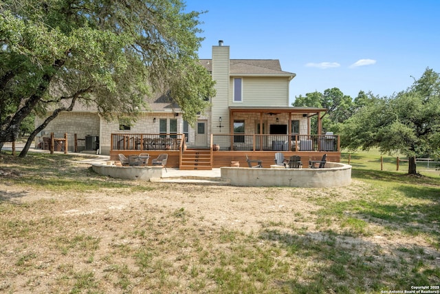 102 Kendall View Dr, Boerne, TX 78006 - back of property featuring a deck, a lawn, a chimney, an outdoor fire pit, and a patio area