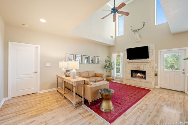 102 Kendall View Dr, Boerne, TX 78006 - living area with wood finished floors, plenty of natural light, a fireplace, baseboards, and a towering ceiling