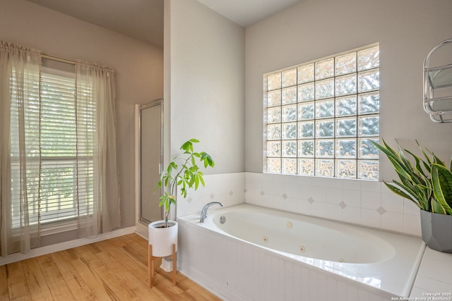 102 Kendall View Dr, Boerne, TX 78006 - bathroom featuring healthy amount of natural light, a jetted tub, wood finished floors, and a stall shower
