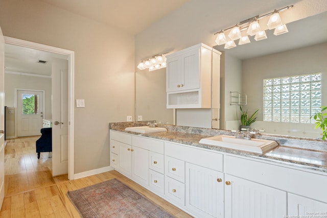 102 Kendall View Dr, Boerne, TX 78006 - full bath featuring wood finished floors, double vanity, and baseboards