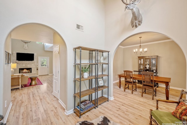 102 Kendall View Dr, Boerne, TX 78006 - foyer entrance featuring arched walkways, light wood-style floors, baseboards, crown molding, and a towering ceiling
