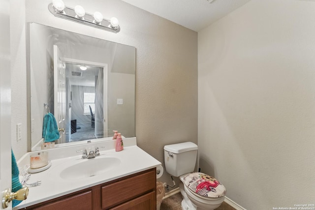10715 Black Wolf Bay, San Antonio, TX 78245 - half bath with toilet, vanity, and a textured wall