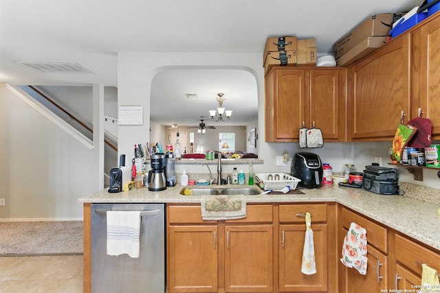 10715 Black Wolf Bay, San Antonio, TX 78245 - kitchen with a sink, dishwasher, brown cabinetry, a chandelier, and light stone counters