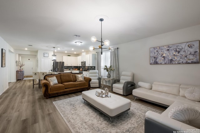 5266 Anzueto, San Antonio, TX 78261 - living room with wood finished floors, a chandelier, and recessed lighting