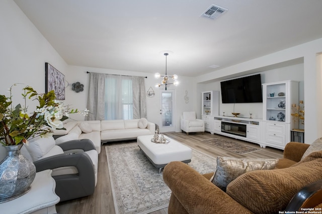 5266 Anzueto, San Antonio, TX 78261 - living room with light wood-style flooring and a chandelier