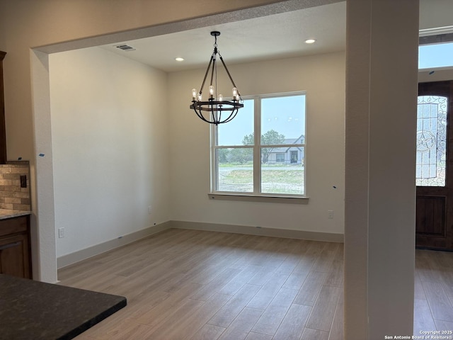 811 Horseshoe Fls, Bandera, TX 78003 - unfurnished dining area featuring a chandelier, light wood-type flooring, baseboards, and recessed lighting