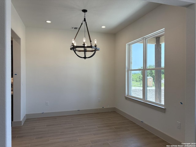 811 Horseshoe Fls, Bandera, TX 78003 - unfurnished room featuring a chandelier, light wood finished floors, baseboards, and recessed lighting
