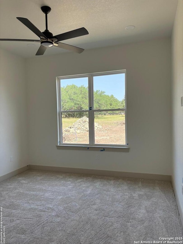 811 Horseshoe Fls, Bandera, TX 78003 - carpeted empty room featuring healthy amount of natural light, ceiling fan, and baseboards