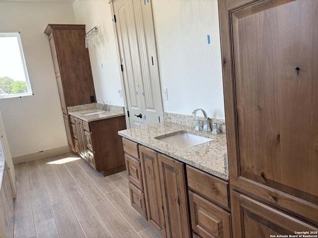 811 Horseshoe Fls, Bandera, TX 78003 - bathroom with two vanities and wood finished floors