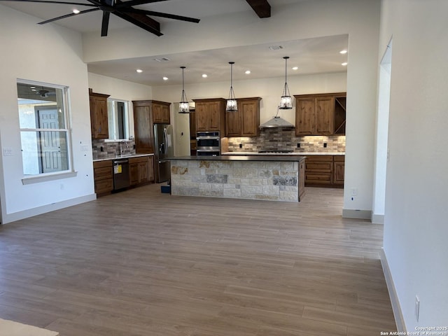 811 Horseshoe Fls, Bandera, TX 78003 - kitchen featuring appliances with stainless steel finishes, tasteful backsplash, a sink, recessed lighting, and wood finished floors