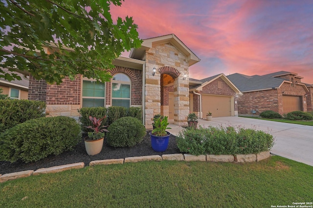 12322 Saddle Up Dr, San Antonio, TX 78254 - view of front of home with stone siding, an attached garage, concrete driveway, brick siding, and a front yard