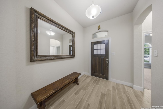 12322 Saddle Up Dr, San Antonio, TX 78254 - foyer featuring arched walkways, light wood-style floors, and baseboards