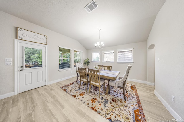 12322 Saddle Up Dr, San Antonio, TX 78254 - dining space featuring a chandelier, light wood-type flooring, vaulted ceiling, and baseboards