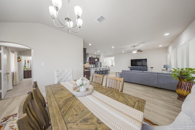 12322 Saddle Up Dr, San Antonio, TX 78254 - dining space featuring light wood finished floors, arched walkways, a ceiling fan, vaulted ceiling, and recessed lighting